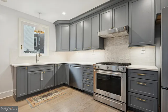 a kitchen with a stove oven and sink