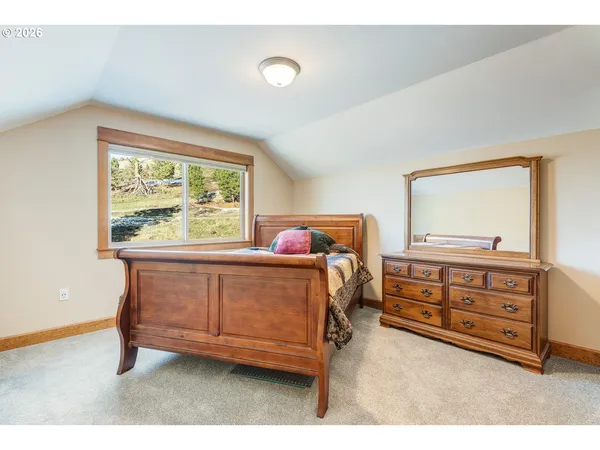 a bedroom with a bed and with furniture