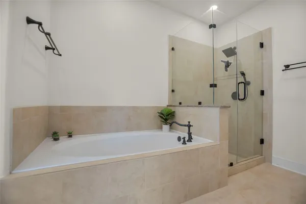 a bathroom with a bathtub and a shower