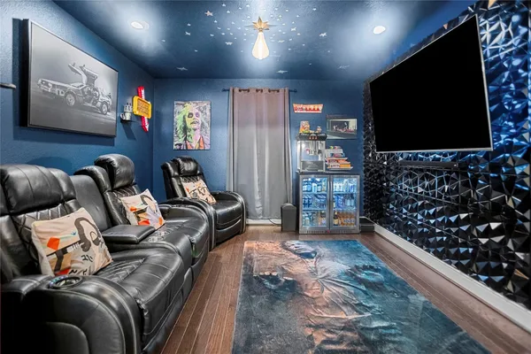 a room with furniture projector and screen