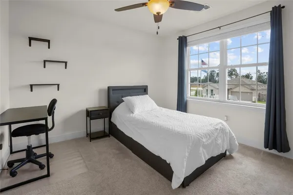 a large bed sitting in a bedroom next to a window