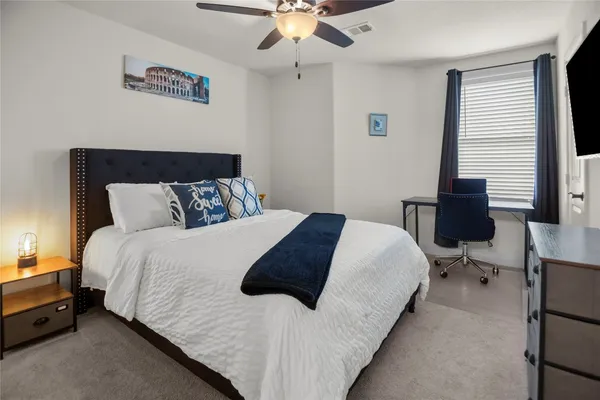 a bedroom with bed and window