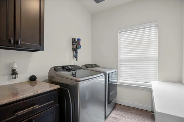 a view of a storage and utility room with washer and dryer