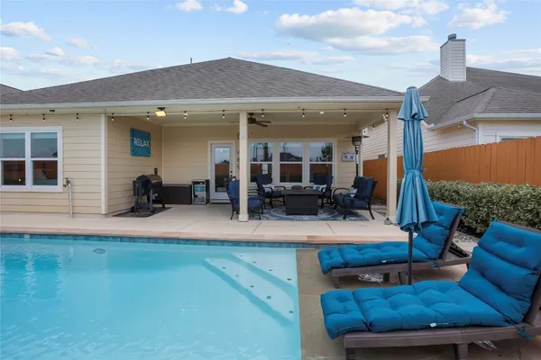 a view of a patio with couches and pool table and chairs