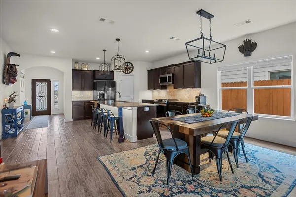 a view of a dining room with furniture window and wooden floor