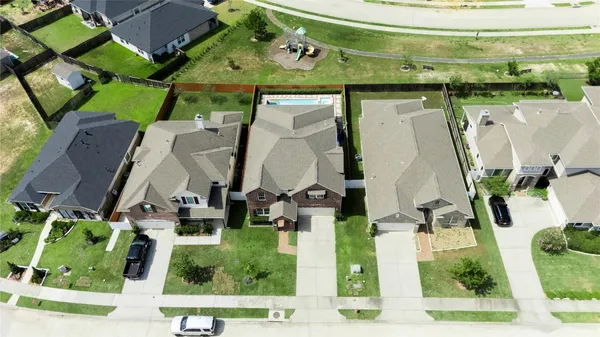 an aerial view of residential houses with outdoor space and street view