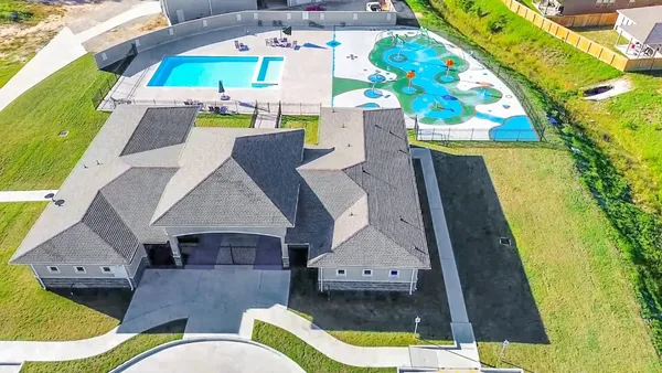 an aerial view of residential houses with outdoor space