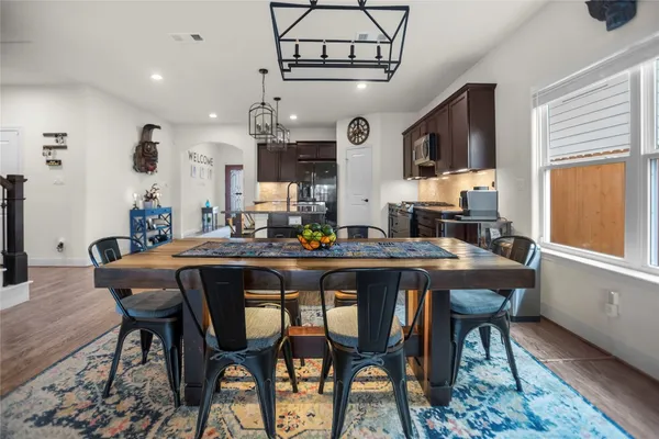 a dining room with a wooden table and chairs