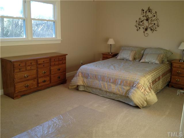 4005 Pleasant Grove Church Road Raleigh, NC 27613 - Photo 8 of 11 a bedroom with a bed and a window