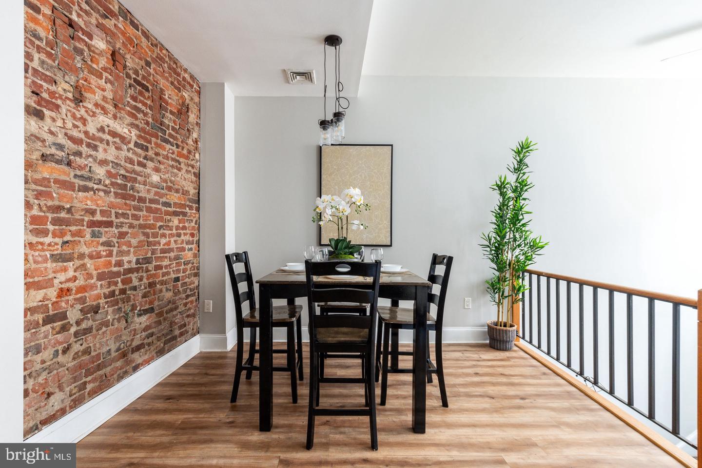 101 Arch Street, Unit 1J Philadelphia, PA 19106 - Photo 14 of 29 a view of a dining room with furniture and wooden floor