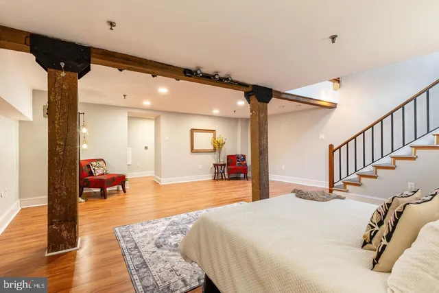 a bed room with a bed and a view of living room