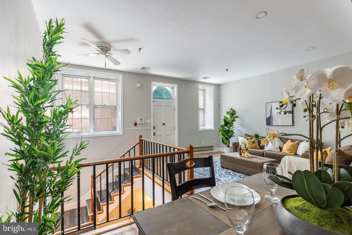 101 Arch Street, Unit 1J Philadelphia, PA 19106 - Photo 5 of 29 a living room with furniture and a potted plant