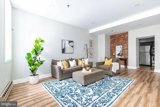 a living room with furniture and a rug