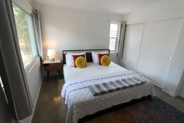 a bed sitting in a bedroom next to a window