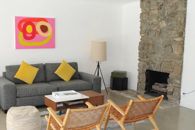 a living room with furniture and a fireplace