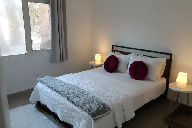 a bedroom with a bed and window