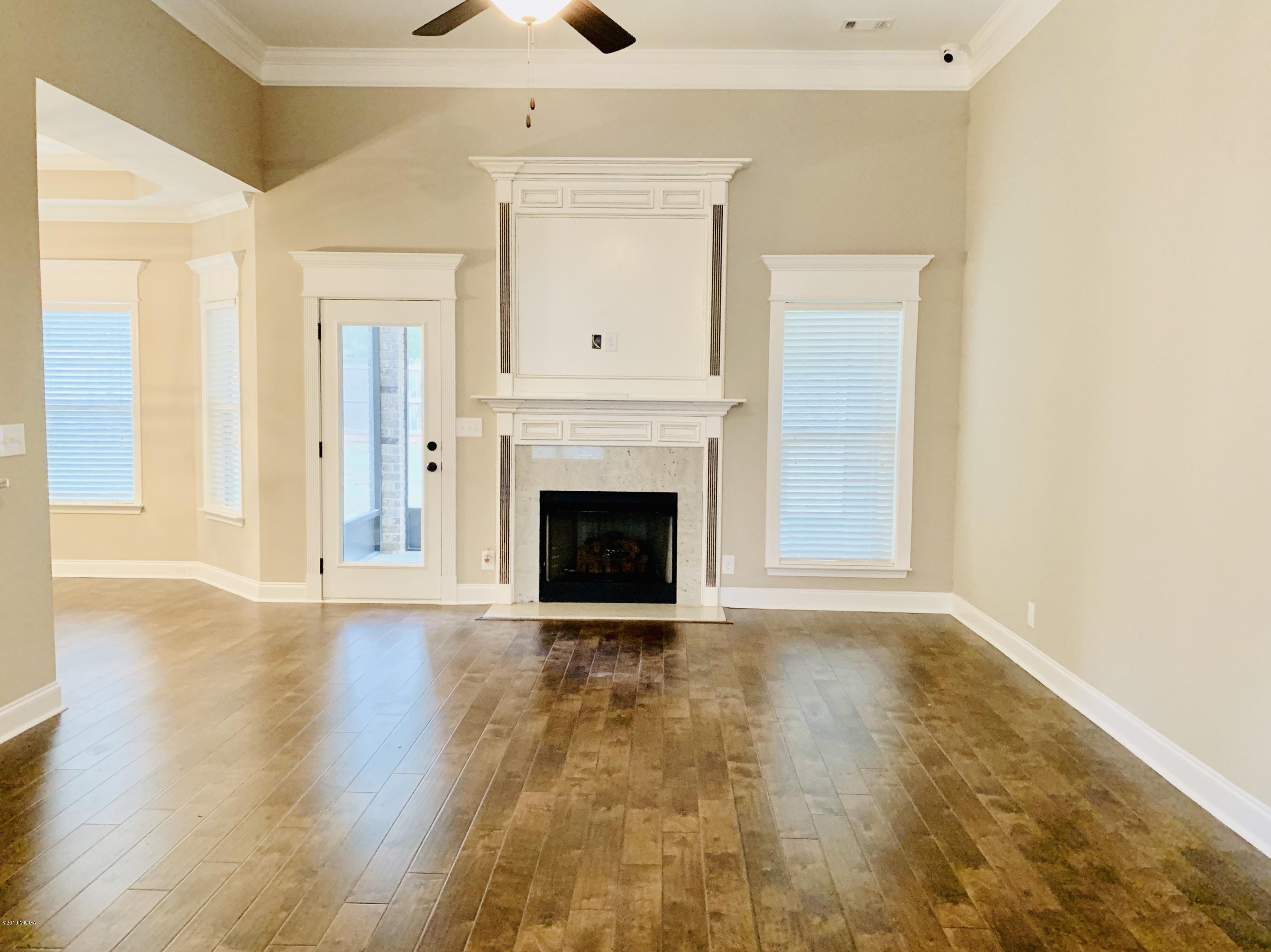 208 Bridgehampton Way Perry, GA 31069 - Photo 3 of 37 a view of a livingroom with wooden floor and a fireplace