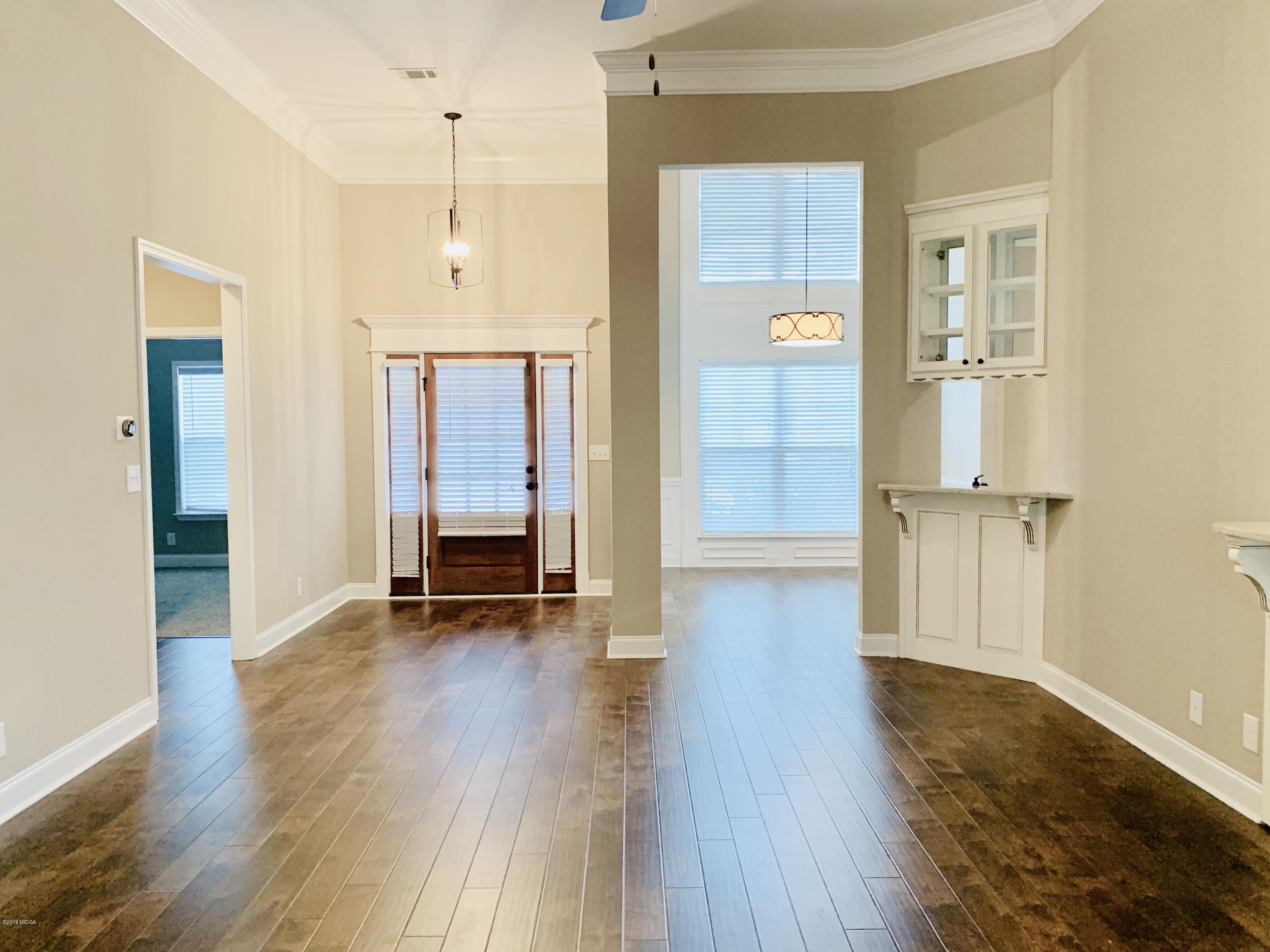 208 Bridgehampton Way Perry, GA 31069 - Photo 5 of 37 wooden floor in an empty room with a window