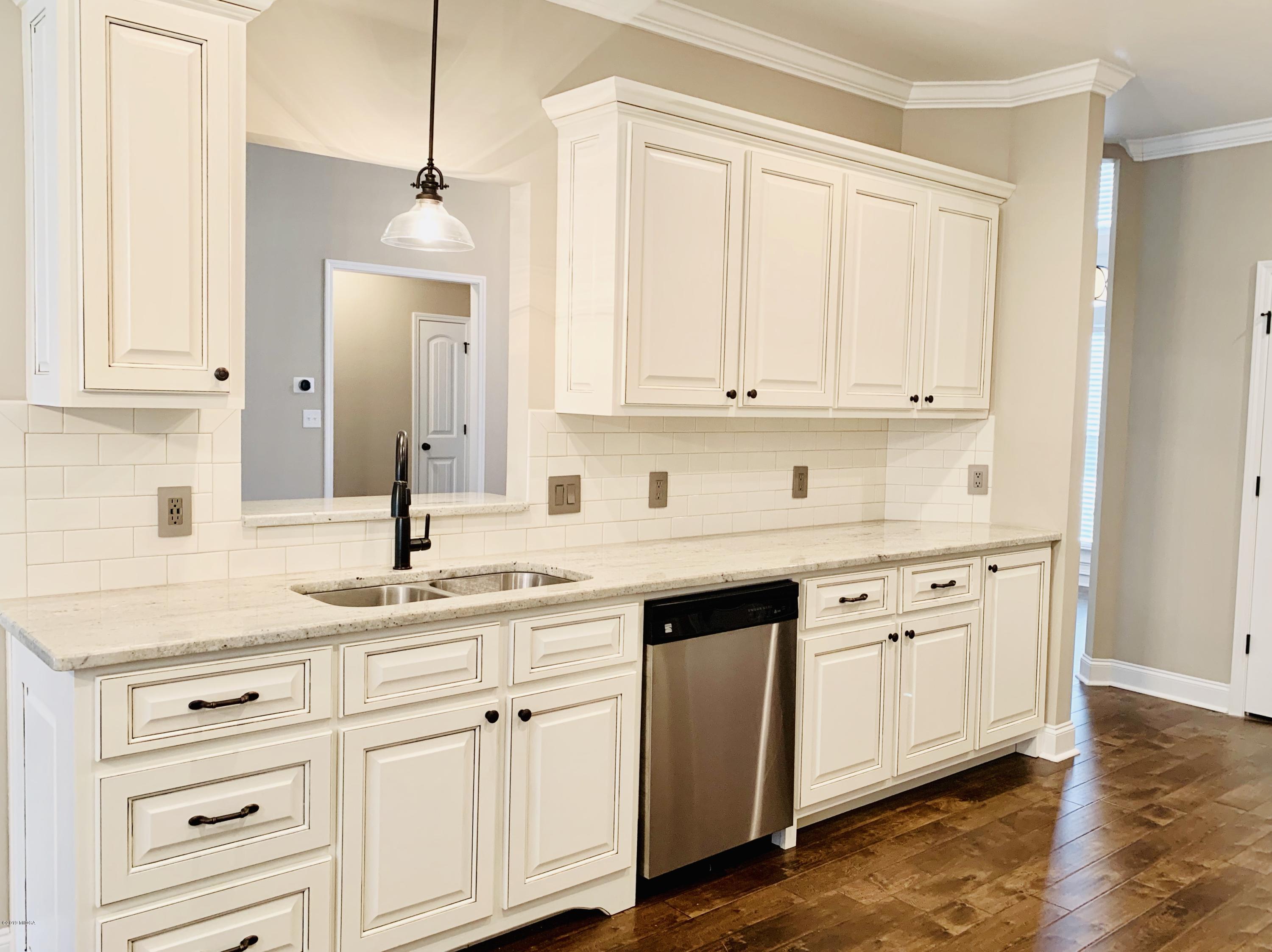 208 Bridgehampton Way Perry, GA 31069 - Photo 8 of 37 a kitchen with granite countertop white cabinets and sink
