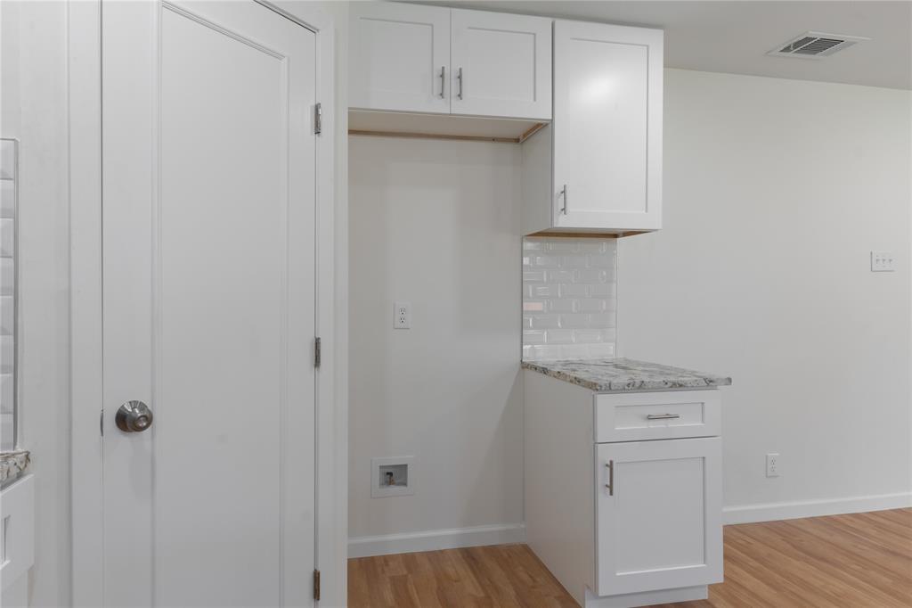 9225 Plano Road Dallas, TX 75238 - Photo 11 of 24 a hallway with washer and dryer