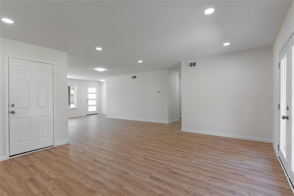 9225 Plano Road Dallas, TX 75238 - Photo 12 of 24 a view of an empty room with wooden floor and closet area