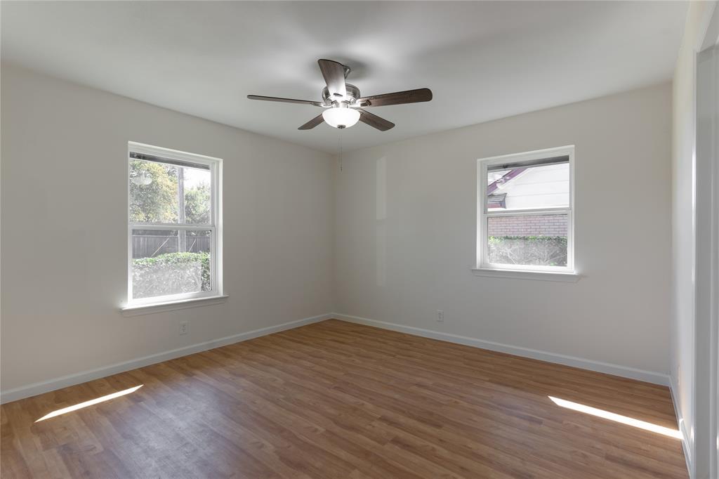 9225 Plano Road Dallas, TX 75238 - Photo 18 of 24 a view of an empty room with wooden floor and a window