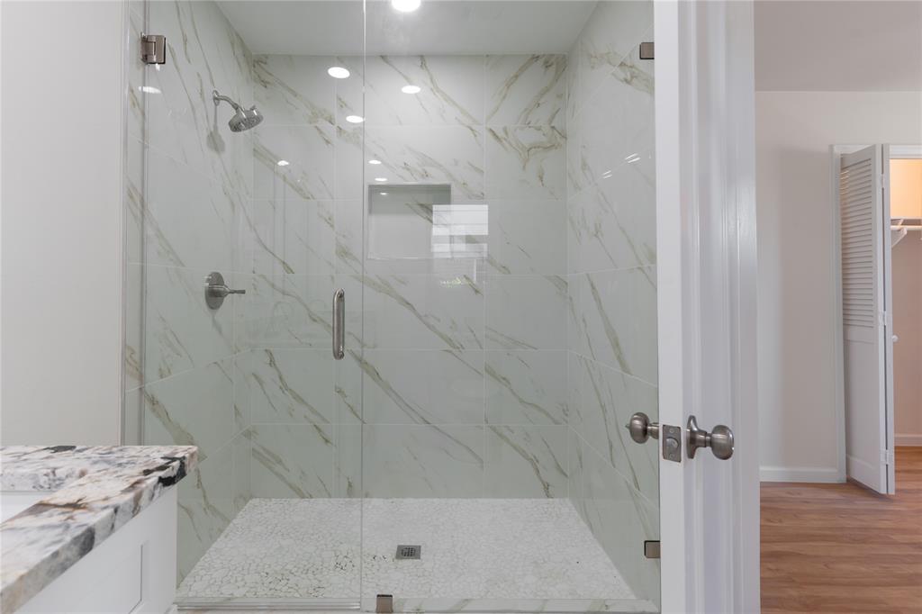 9225 Plano Road Dallas, TX 75238 - Photo 21 of 24 a bathroom with a granite countertop sink a toilet and shower