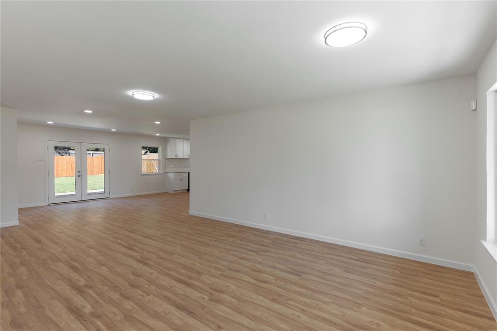 9225 Plano Road Dallas, TX 75238 - Photo 4 of 24 a view of empty room with wooden floor and window