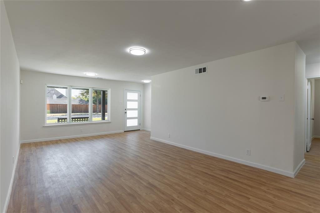 9225 Plano Road Dallas, TX 75238 - Photo 5 of 24 a view of empty room with wooden floor and fan