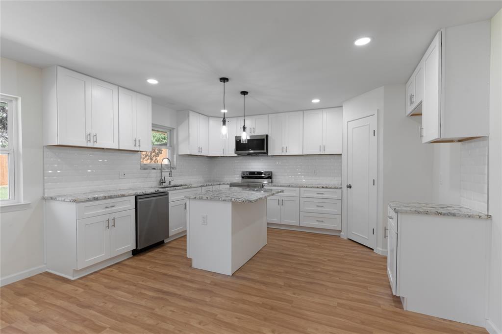 9225 Plano Road Dallas, TX 75238 - Photo 8 of 24 a kitchen with a refrigerator stove top oven and sink