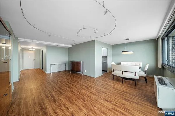 a bedroom with furniture and wooden floor