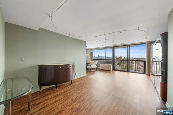 a view of a room with window and wooden floor