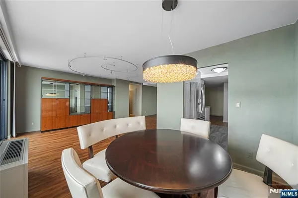 a large living room with furniture and a chandelier