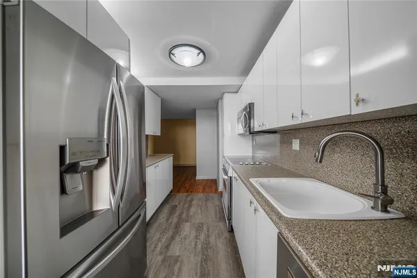 a kitchen with a sink stove and refrigerator