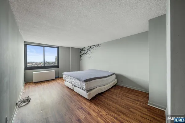 a living room with a bed furniture and a wooden floor