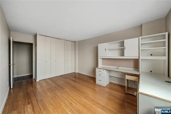 a room with a wooden floor and closet