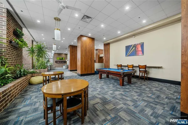 a living room with furniture and a pool table