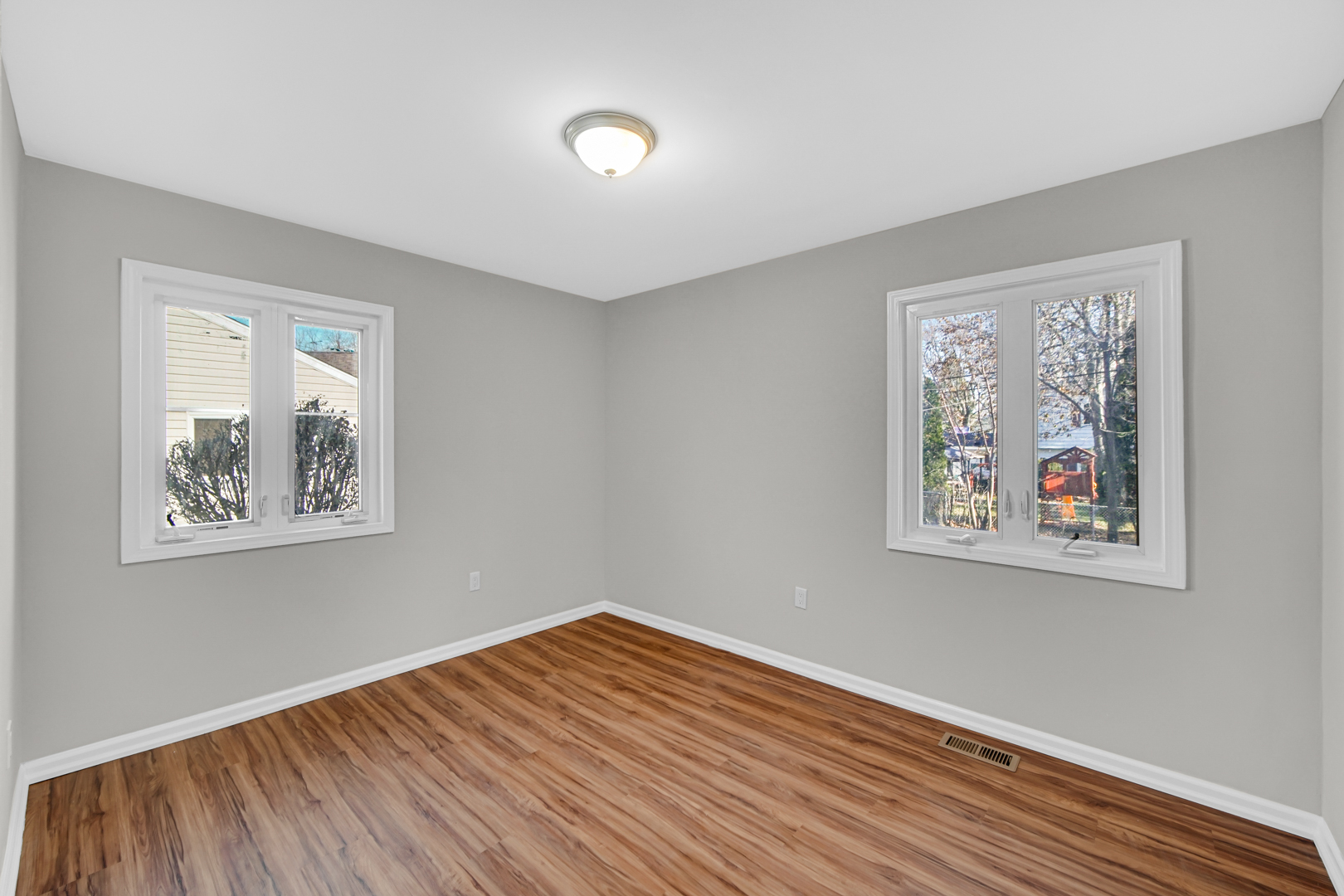 407 Dalhart Avenue Romeoville, IL 60446 - Photo 11 of 17 a view of an empty room with wooden floor and a window