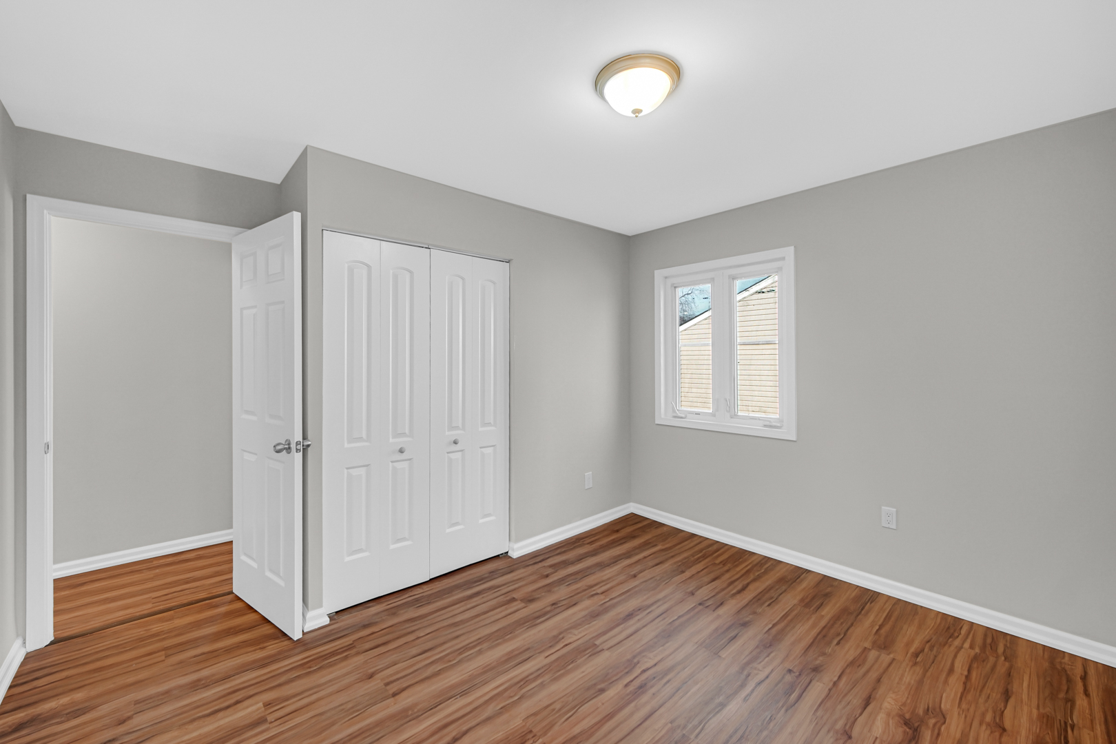 407 Dalhart Avenue Romeoville, IL 60446 - Photo 12 of 17 an empty room with wooden floor and windows