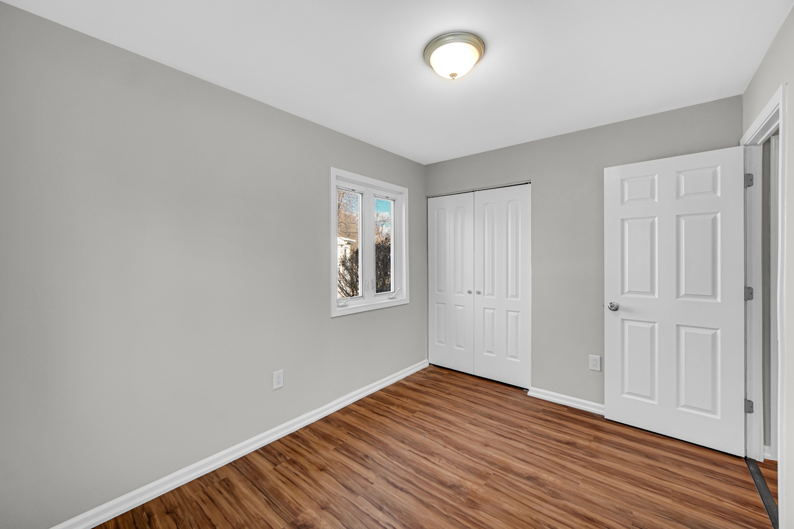 407 Dalhart Avenue Romeoville, IL 60446 - Photo 14 of 17 an empty room with wooden floor and windows