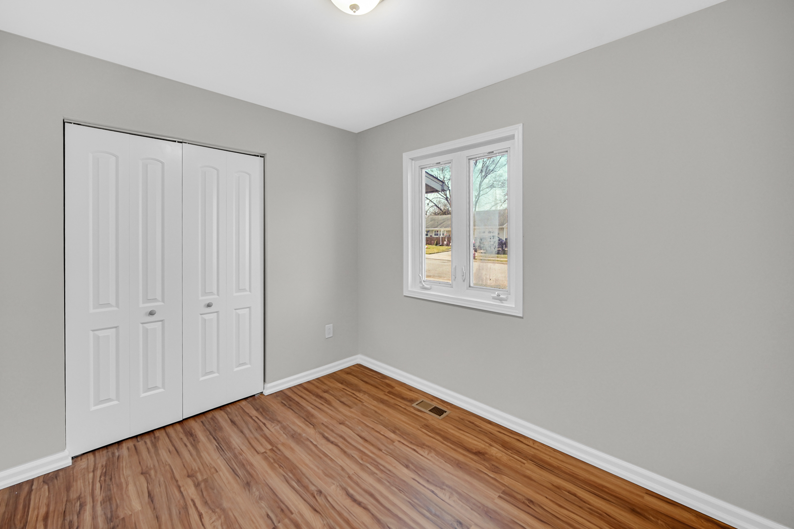 407 Dalhart Avenue Romeoville, IL 60446 - Photo 15 of 17 a view of an empty room with wooden floor and a window