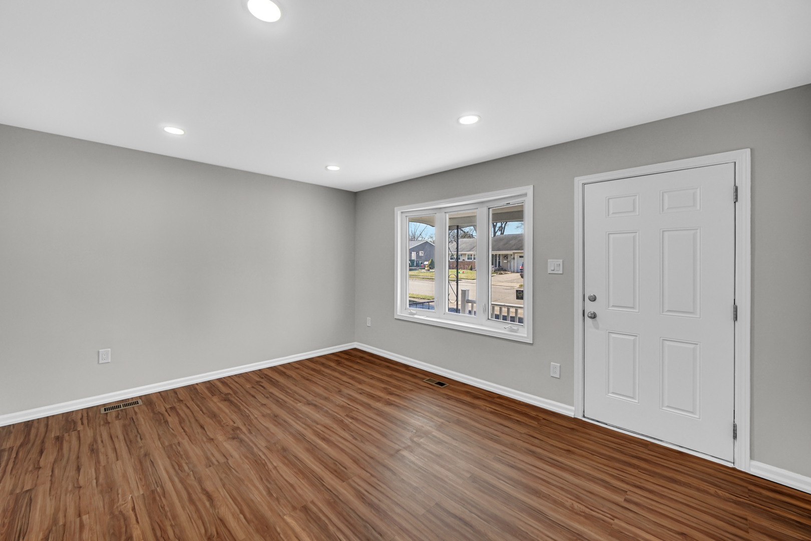 407 Dalhart Avenue Romeoville, IL 60446 - Photo 6 of 17 a view of an empty room with wooden floor and a window