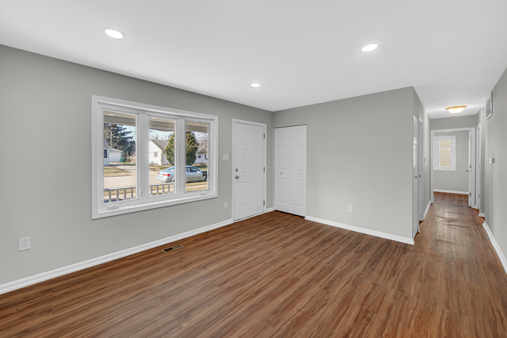 407 Dalhart Avenue Romeoville, IL 60446 - Photo 7 of 17 a view of an empty room with wooden floor and a window