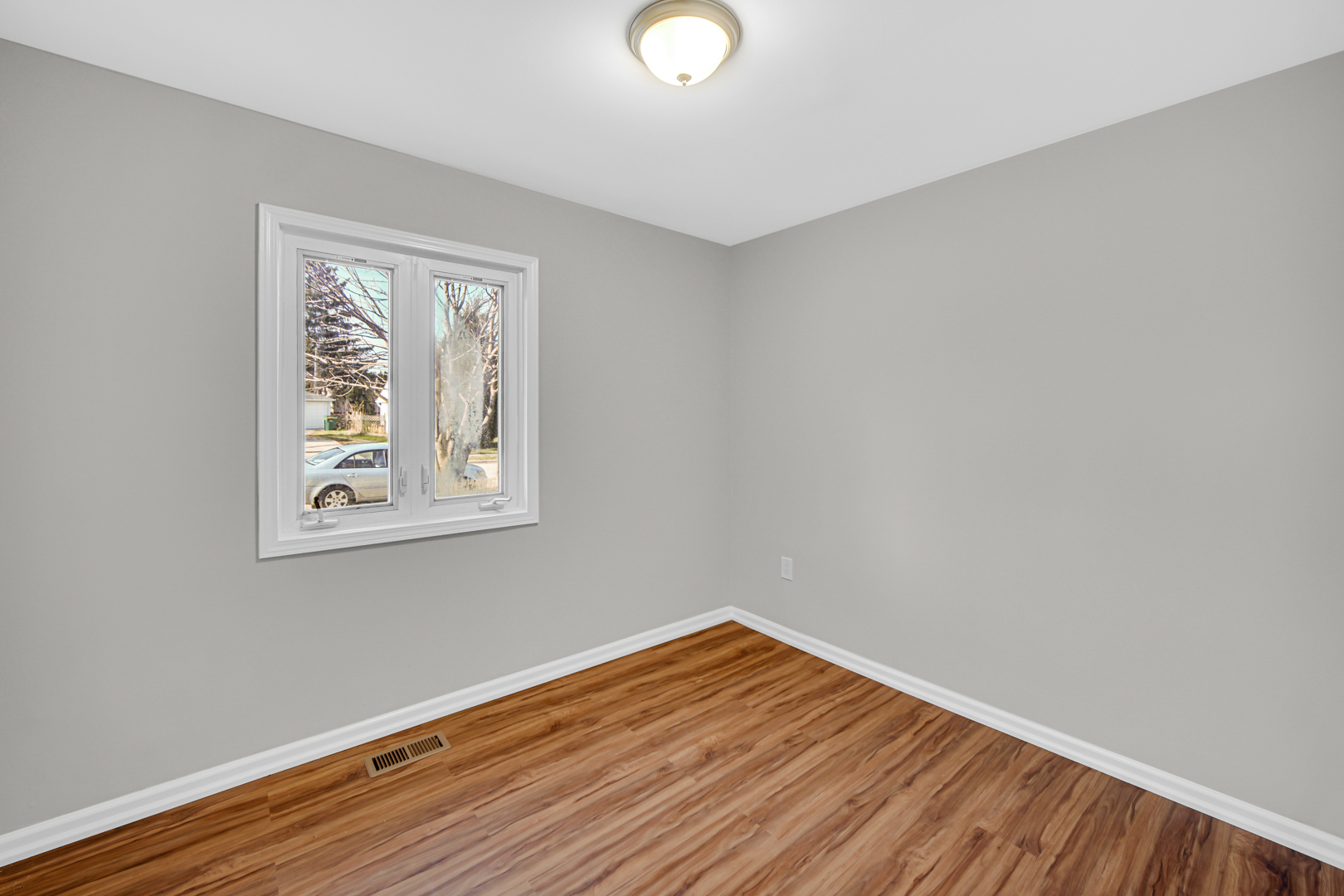 407 Dalhart Avenue Romeoville, IL 60446 - Photo 10 of 17 a view of an empty room with wooden floor and a window