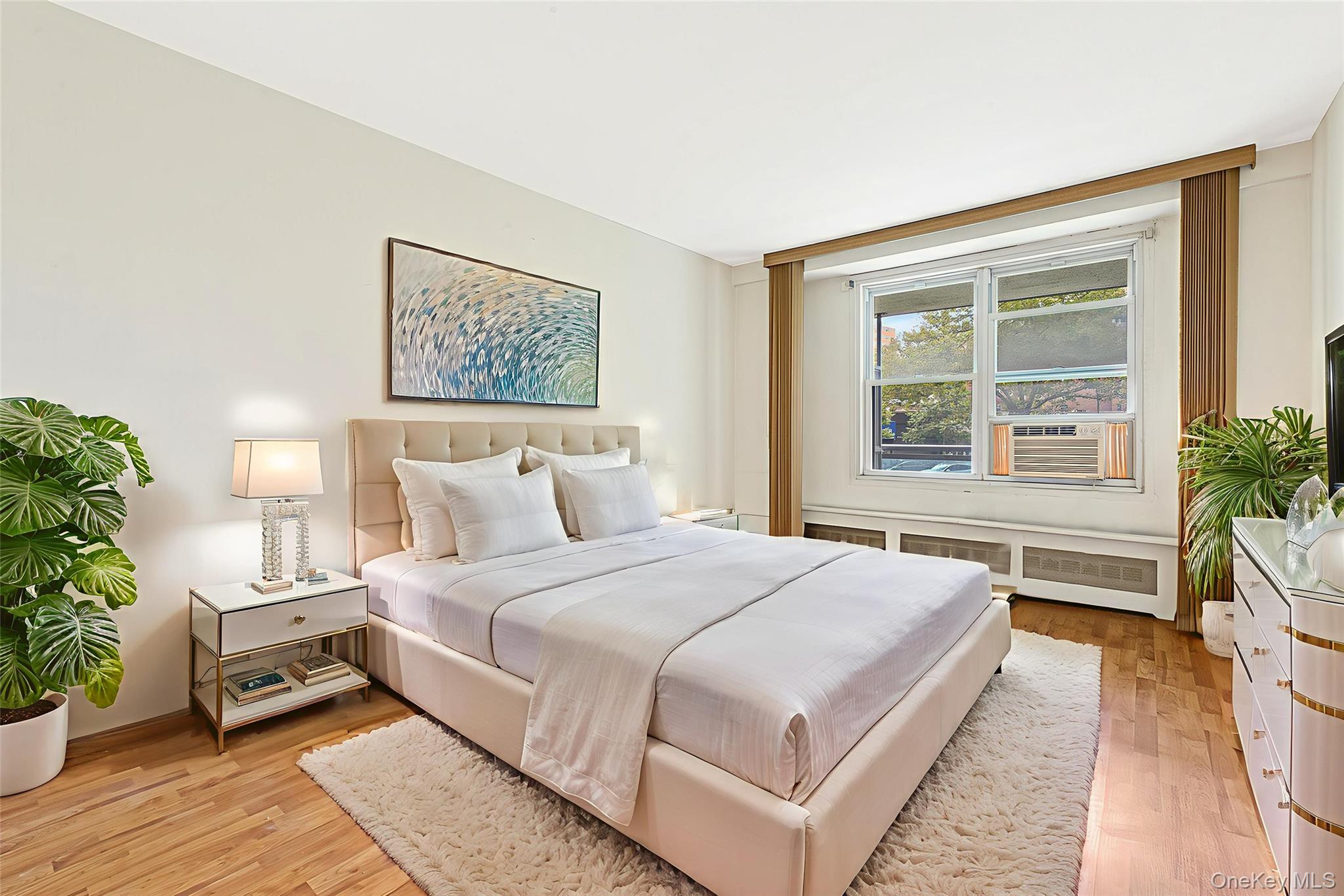 97-37 63rd Road, Unit 2/B Queens, NY 11374 - Photo 18 of 26 a bedroom with a large bed and a potted plant