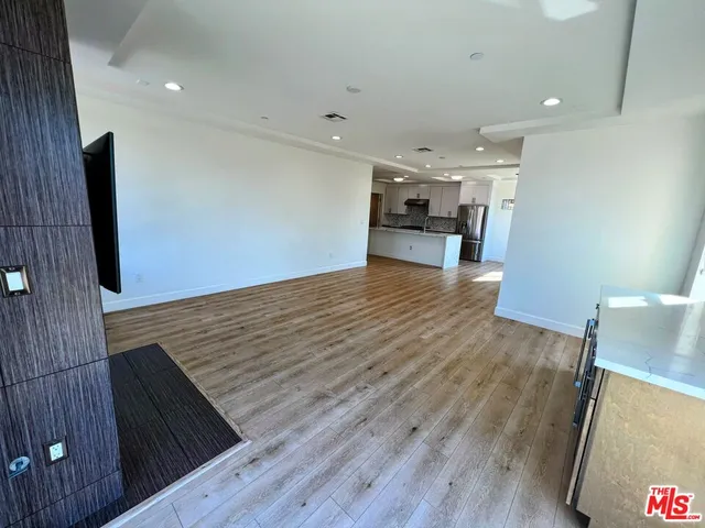 a view of kitchen and hall with wooden floor