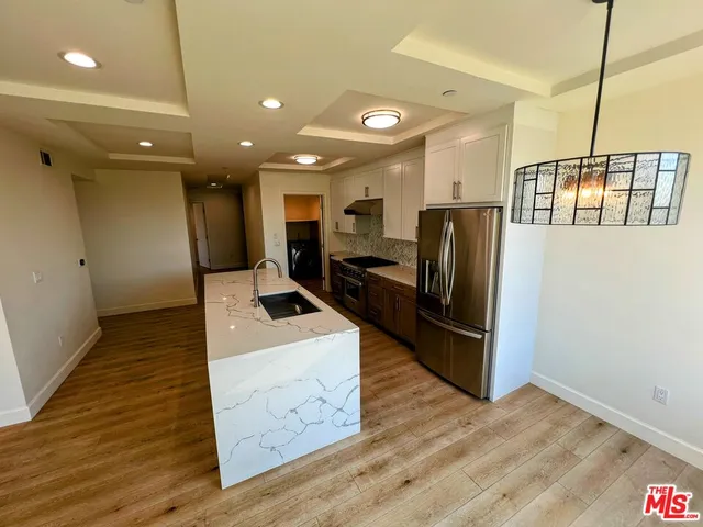 a large kitchen with lots of counter space and stainless steel appliances
