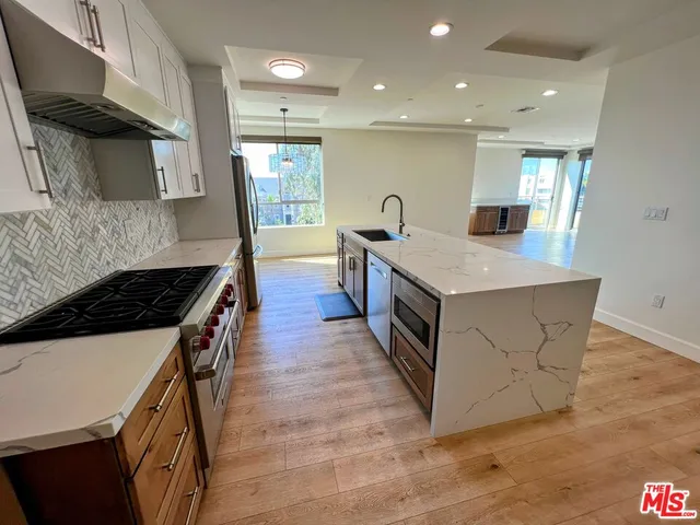 a kitchen with stainless steel appliances granite countertop a stove and a sink