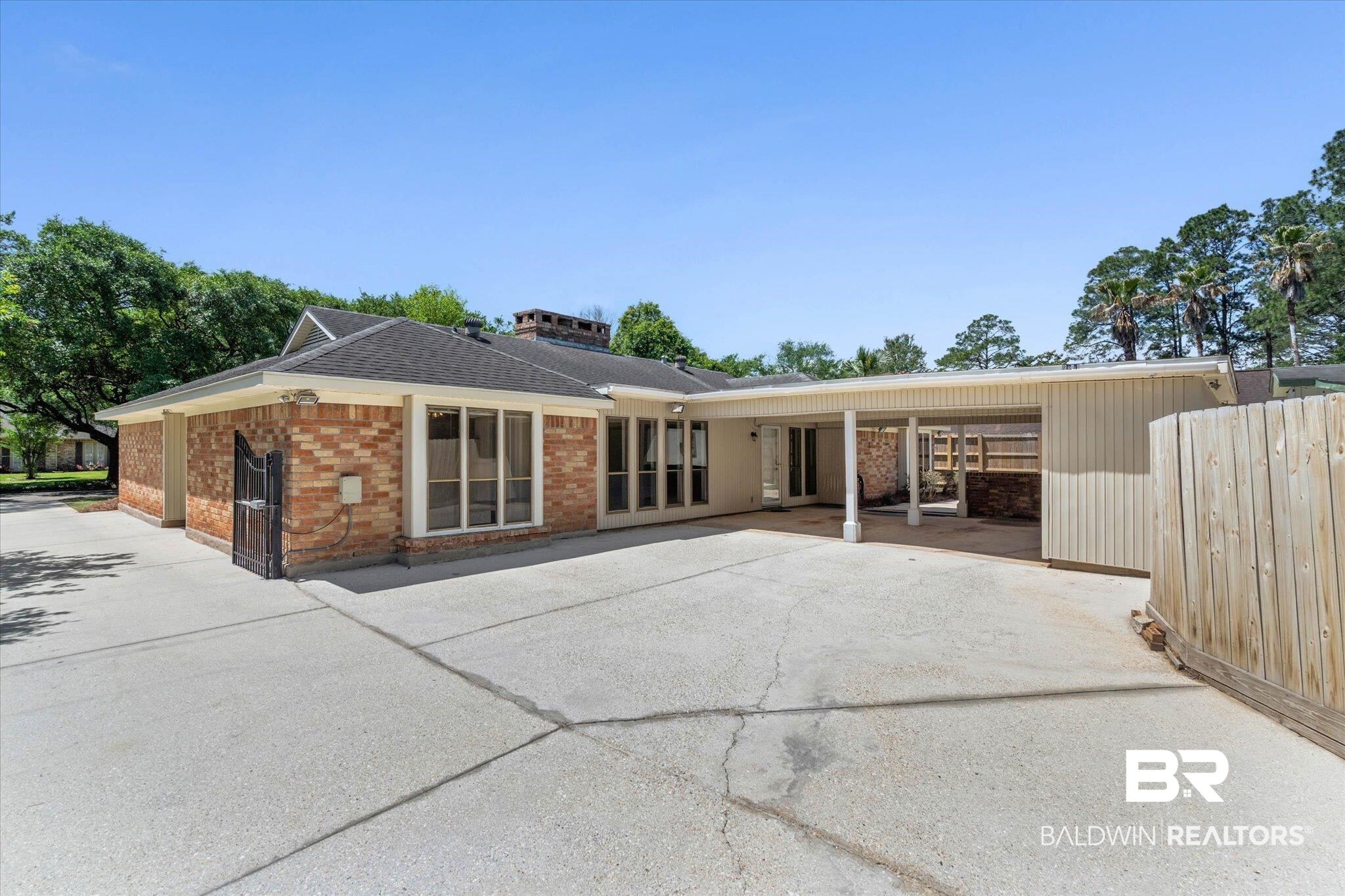 3724 Claridge Road South Mobile, AL 36608 - Photo 39 of 42 Back of property featuring brick siding, a patio, and a shingled roof