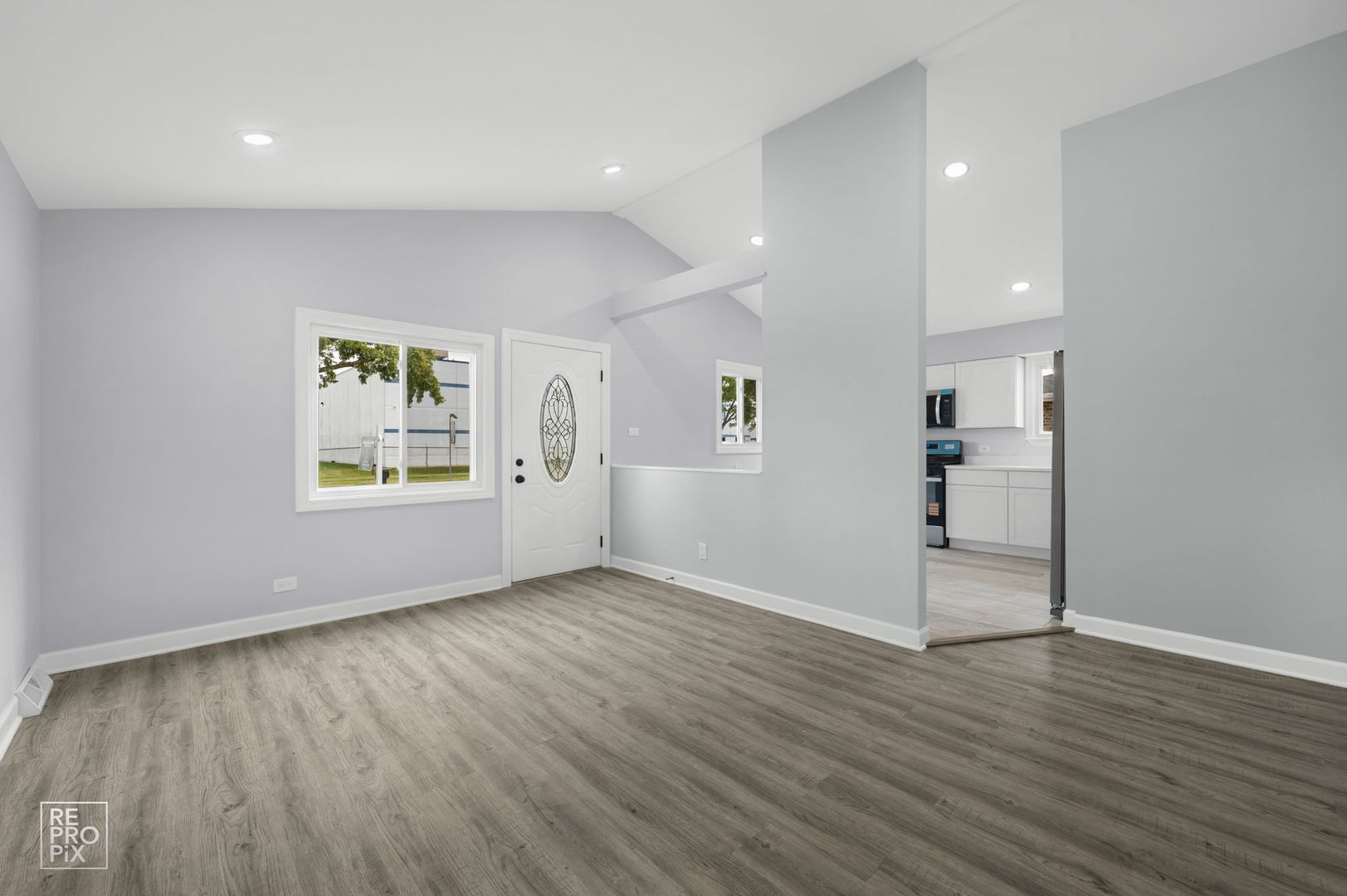 7616 South 78th Avenue Bridgeview, IL 60455 - Photo 2 of 10 an empty room with wooden floor and windows